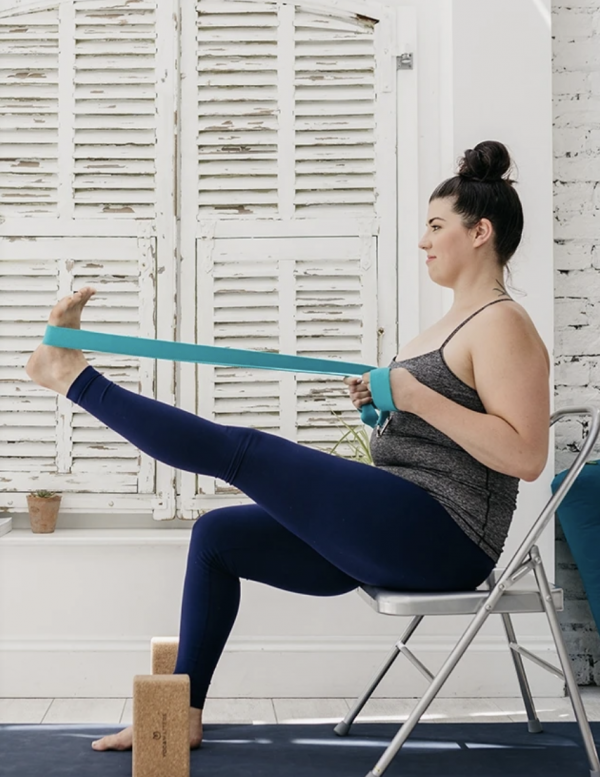 Yoga student using yoga strap